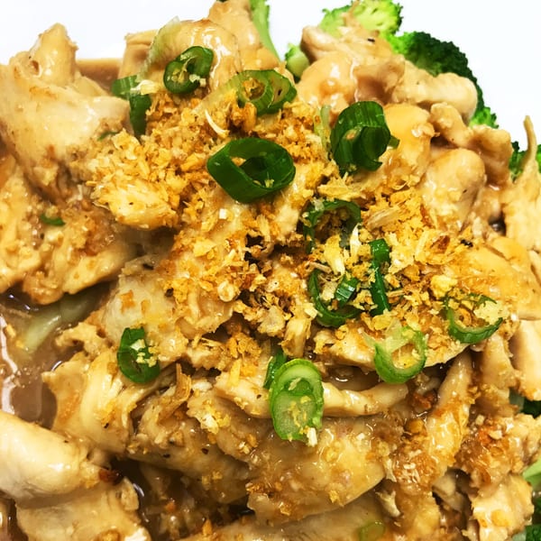 Garlic chicken with crispy garlic, green onions, and broccoli from Thai Delight Norman.
